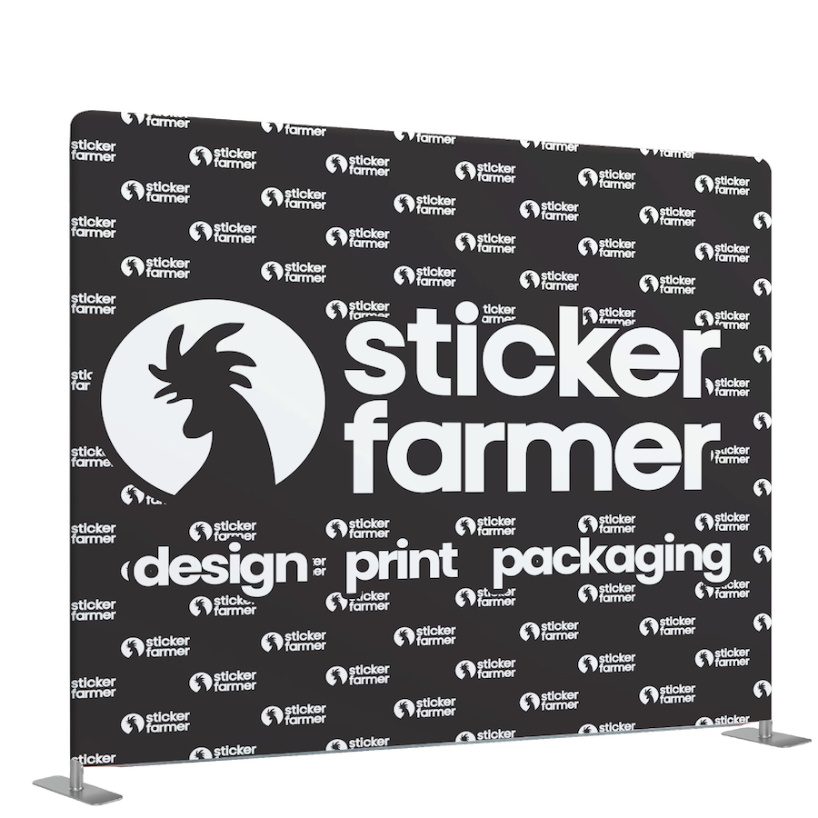 A custom tension fabric backdrop with a black and white design showcasing the brand 'Sticker Farmer' and their services like design, print, and packaging.