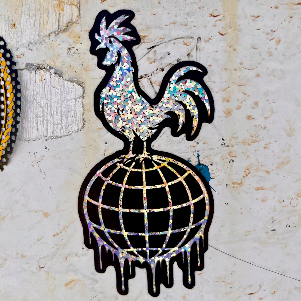 Glitter sticker featuring a rooster standing on a dripping disco ball design with a bold black outline, shown on a textured white surface.
