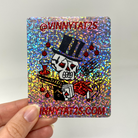 Custom holographic glitter sticker with a skull magician design, red lettering, and rounded square corners.
