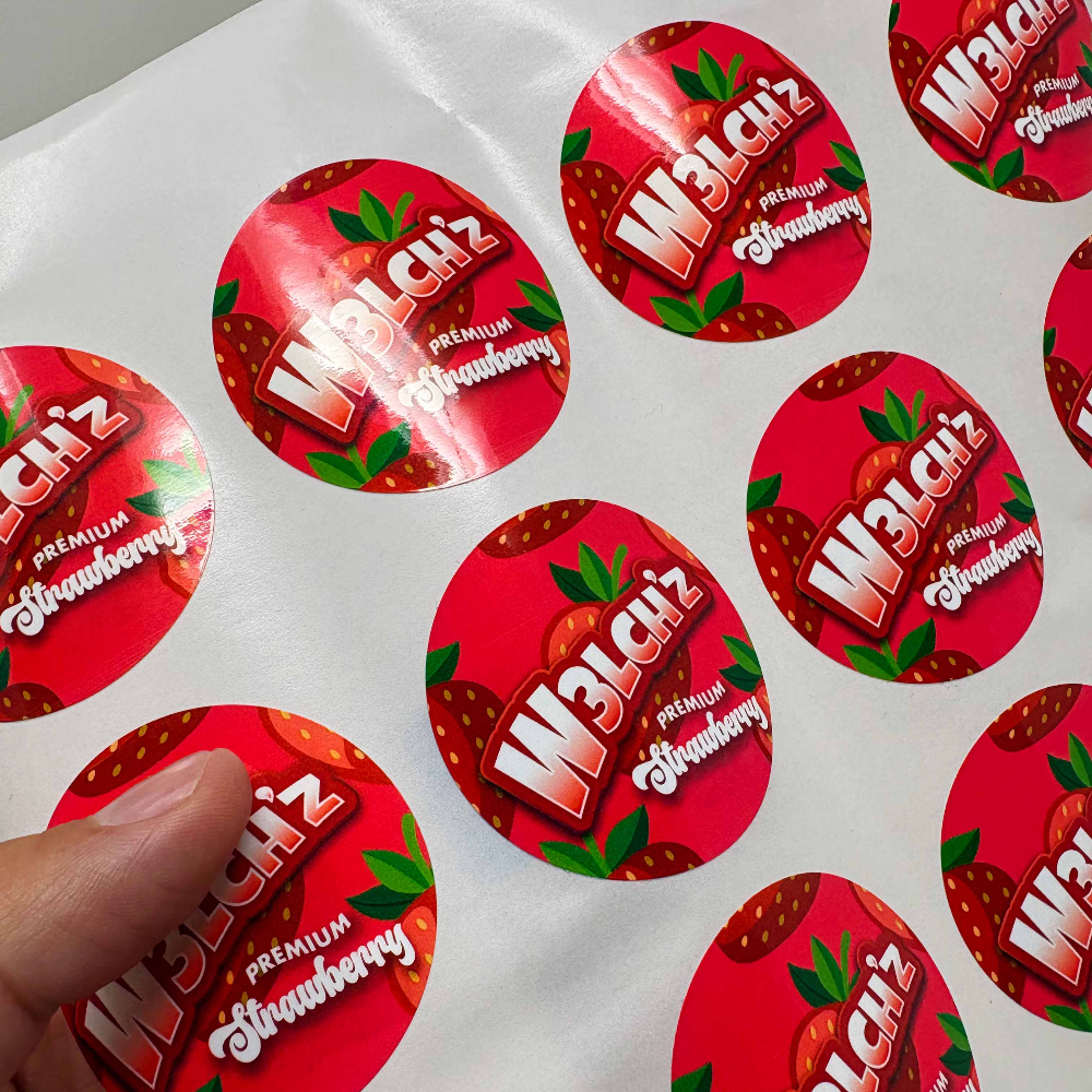 Sheet of custom round strawberry product labels with a glossy finish on white backing paper.